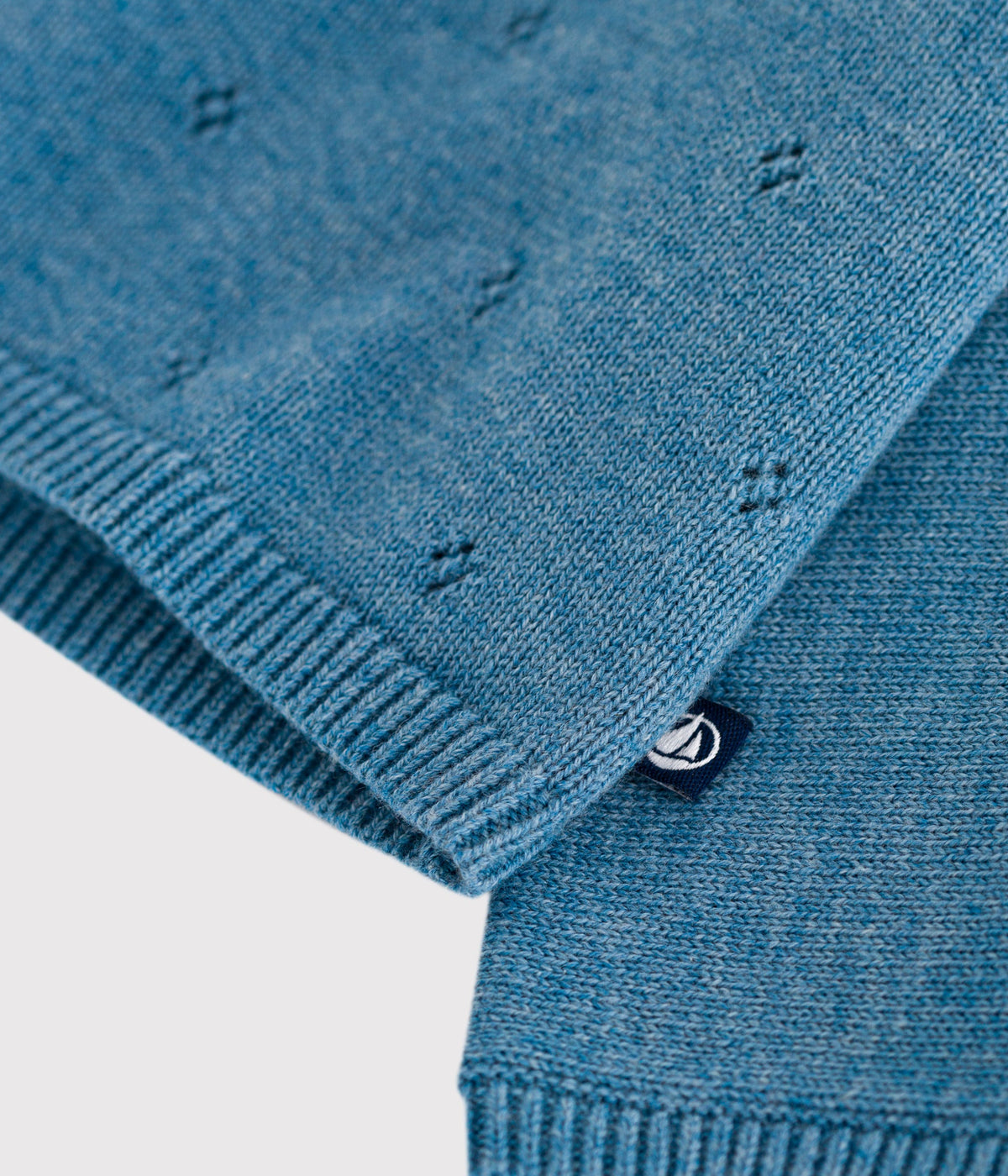 Openwork wrap-style baby cardigan in wool and cotton knit