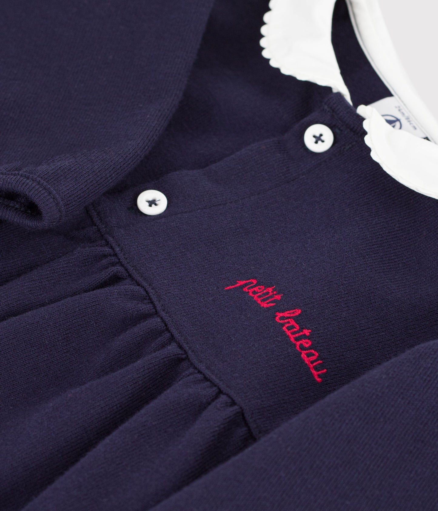 Robe bébé en coton manhces longues unie à col et détails brodés